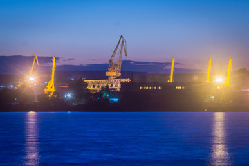 Bulgarian industrial port at night with cranes
