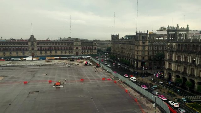 Constitution Plaza in Zocalo, Mexico City, Mexico. Traffic around the plaza on a rainy afternoon. Government offices, National Palace and Mexico City Metropolitan Cathedral. Federal District.