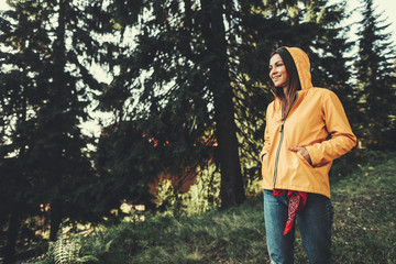 I am ready for adventures. Portrait of charming girl in yellow jacket enjoying sunny day in...