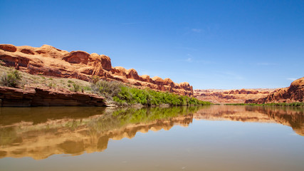Water view from the Colorado River along the bluffs and rock sculpture outside Moab, Utah