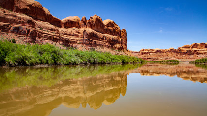 Water view from the Colorado River along the bluffs and rock sculpture outside Moab, Utah