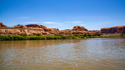 Water view from the Colorado River along the bluffs and rock sculpture outside Moab, Utah