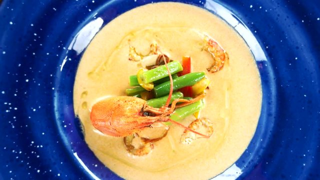 Cream soup with crayfish tails. Garnished food top view.