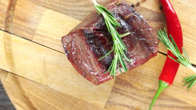 Sirloin steak with rosemary. Barbecue beef top view.