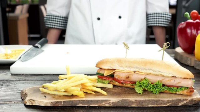 Fast food on wood board. Sandwich and fries.
