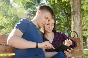 couple guy and girl read news on tablet