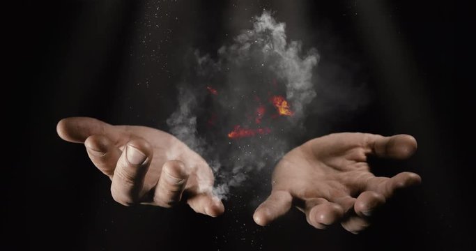 Magicians hands with fire and smoke