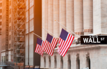 Wall street sign in New York City with New York Stock Exchange background, USA