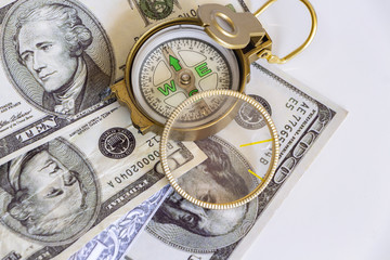 Defective compass placed on the United States dollar banknotes. The concept of direction of financial or investment at present and in the future.