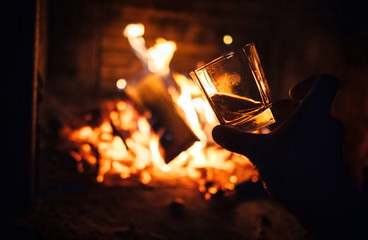Whiskey glass with bonfire background
