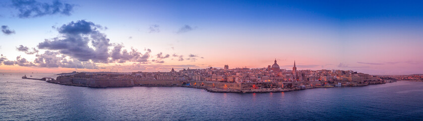 Fototapeta na wymiar La Valletta sunrise with blue, orange, red, yellow sky in Malta
