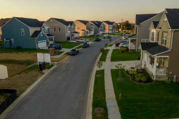 American single family homes at a East Coast Maryland USA new construction aerial view at sunset with vynil siding for upper middle class families