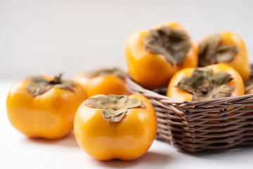 Ripe persimmon fruit in a basket