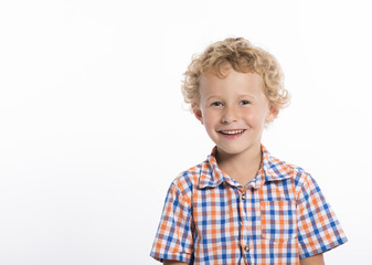 Happy, smiling, blonde, curly haired boy, isolated on white background