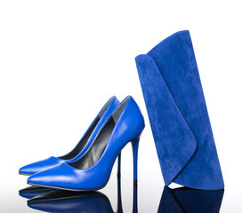 blue high heels pointed woman shoes and hand bag on reflective floor