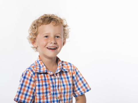 Sweet, smiling little boy with happy expression, isolated on white background