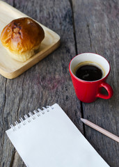 Hot coffee drink and bun bread with notepad and pencil for Life style backgrounds