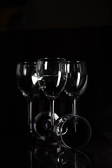 Four champagne glasses on a black background.