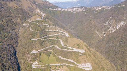 Drone aerial view of the mountain road in Italy that connects the village of Nebro to Selvino....