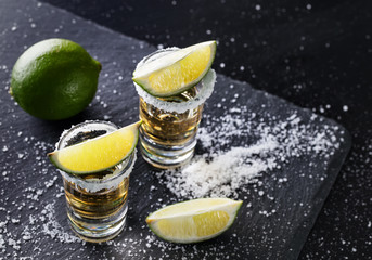 Two glasses with tequila and lime