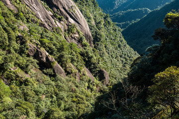 valley floor under the green covered mountain ridges on a sunny day