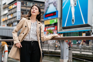 beautiful office lady standing next to the river