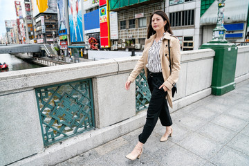 young lady walking in front of Glico running man
