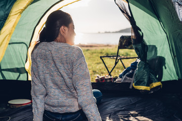 Back one woman inside view camping tent in summer