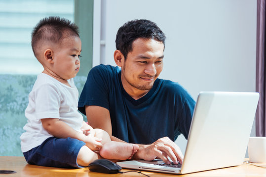 Man father working on laptop computer