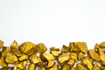 A pile of gold nuggets or gold ore on white background, precious stone or lump of golden stone, financial and business concept.
