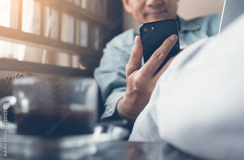 Poster man using smartphone and laptop computer