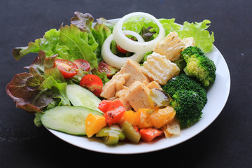 Healthy salad with chicken on black background . Food and health. Clean eating, dieting food concept.