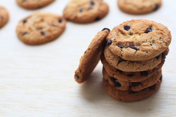 Cookies with chocolate on dark wooden background.