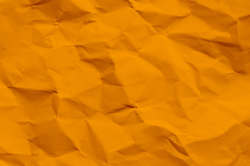 Orange background and wallpaper by crumpled paper texture and free space.