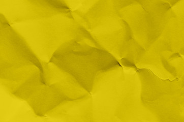 Yellow background and wallpaper by crumpled paper texture and free space.