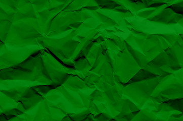 Green background and wallpaper by crumpled paper texture and free space.