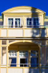 Balconies on an old yellow wooden house