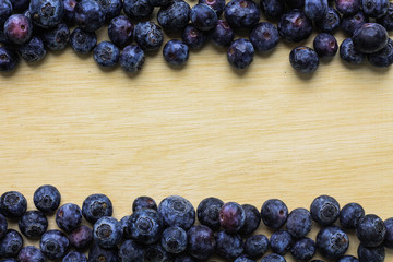 blueberry frame on wooden background. for healthy food concept. with space for add text.
