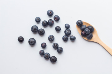 blueberry with wood spoon on white background. for healthy food concept.