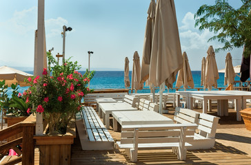 Fototapeta premium tables and benches against the sea