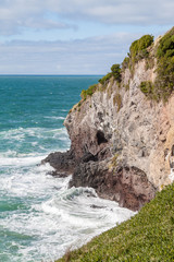 Fototapeta na wymiar Waves crashing on cliff (5)