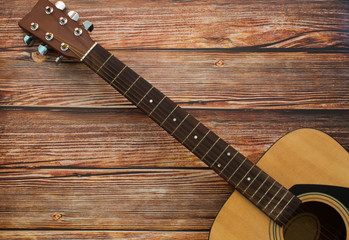 Fototapeta premium Acoustic guitar on wooden background. Music and melody concept.