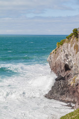 Fototapeta na wymiar Waves crashing on cliff (3)