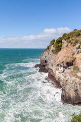 Waves crashing on cliff 