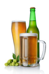 Bottle and glasses of cold light beer with foam and green hops