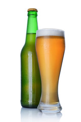 Bottle and glass of cold light beer with foam