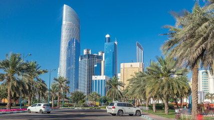 Fototapeta na wymiar Corniche boulevard beach park along the coastline in Abu Dhabi timelapse with skyscrapers on background.