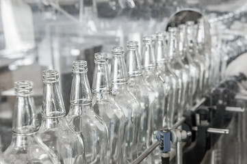on the conveyor belt glass bottles. factory shop for the production of glass bottles and beverage
