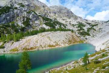 Mountain lake with turquoise water in Julian Alps (Jezero v Ledvicah) on a hiking trail called...