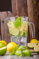 Lime lemons limonade, fresh herbs and ice in